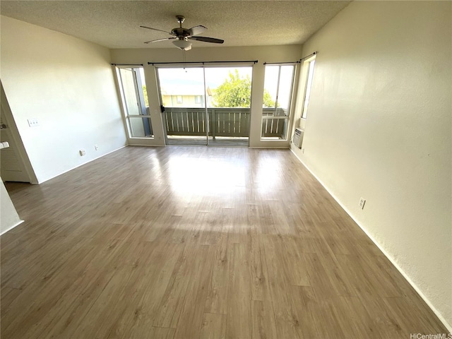 91-241 Hanapouli Cir Unit 24H, Ewa Beach, HI 96706 - spare room with ceiling fan, wood finished floors, and a textured ceiling