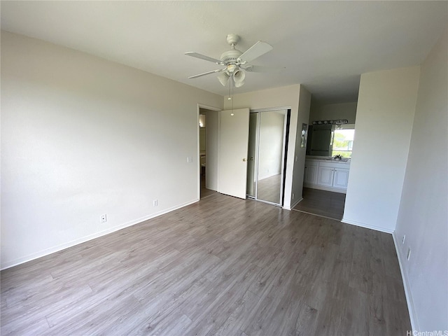91-241 Hanapouli Cir Unit 24H, Ewa Beach, HI 96706 - unfurnished bedroom with a closet, wood finished floors, and a ceiling fan