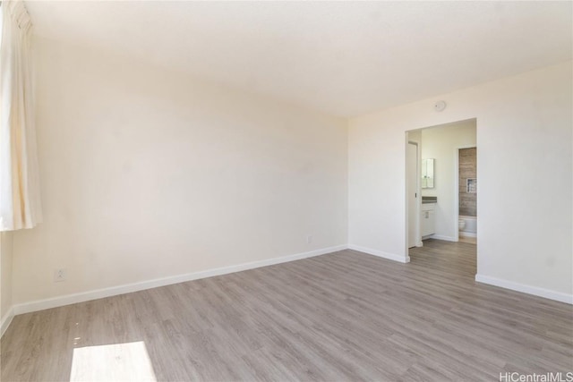 empty room featuring baseboards and wood finished floors