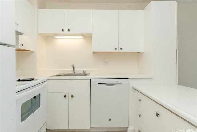 kitchen with a sink, white appliances, white cabinets, and light countertops