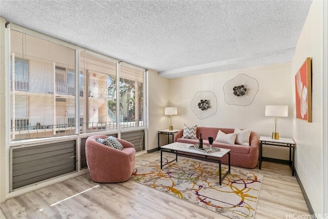 living room with wood finished floors and a textured ceiling