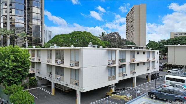 view of building exterior featuring a view of city and uncovered parking