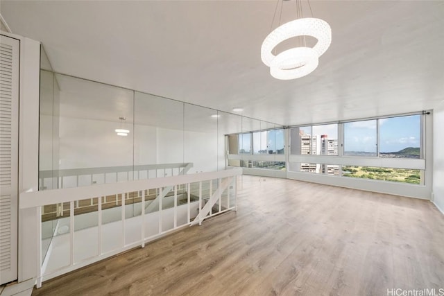 spare room with plenty of natural light and wood finished floors