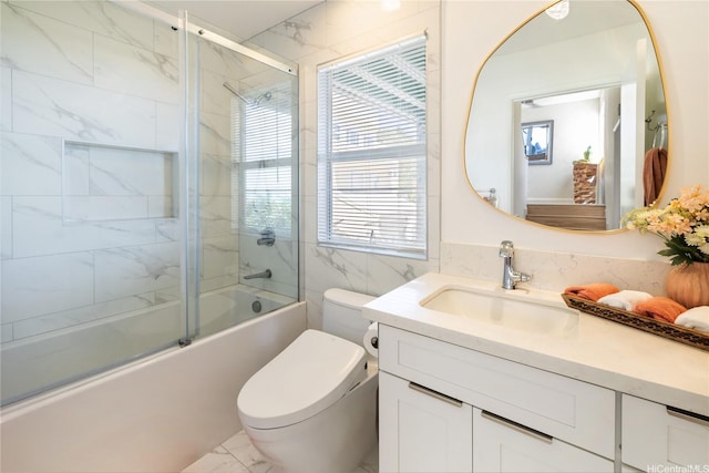 45-081 Lilipuna Rd Unit F, Kaneohe, HI 96744 - bathroom with marble look tiles, shower / bath combination with glass door, vanity, toilet, and tile walls
