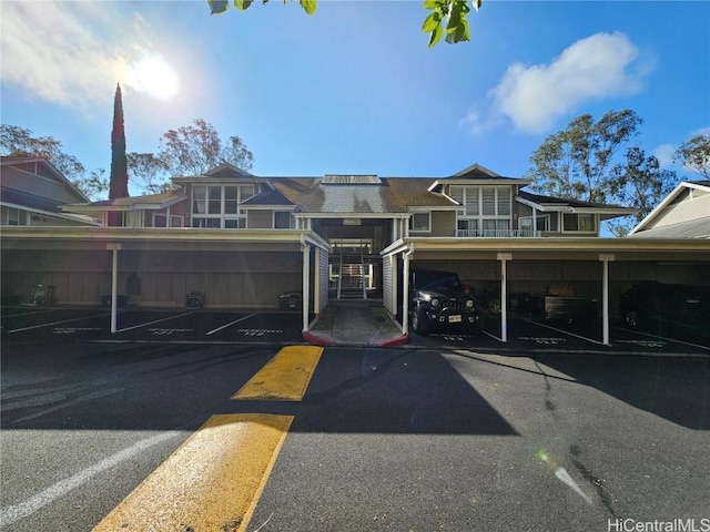 view of front of property featuring covered parking