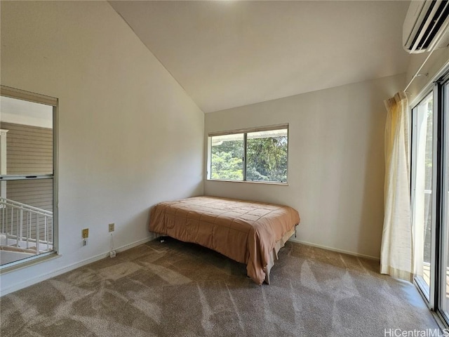 carpeted bedroom featuring baseboards, multiple windows, and a wall mounted AC