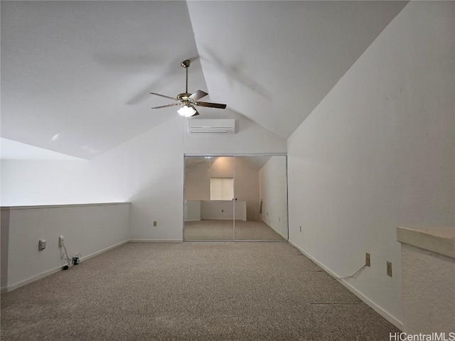 additional living space with an AC wall unit, carpet flooring, baseboards, and vaulted ceiling