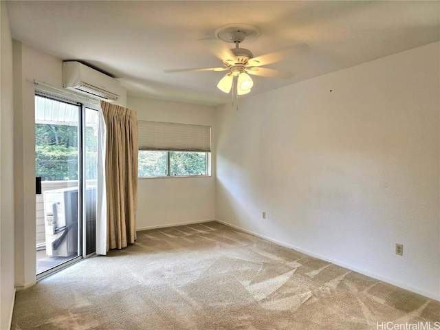 empty room featuring a wall mounted AC, a ceiling fan, and light carpet