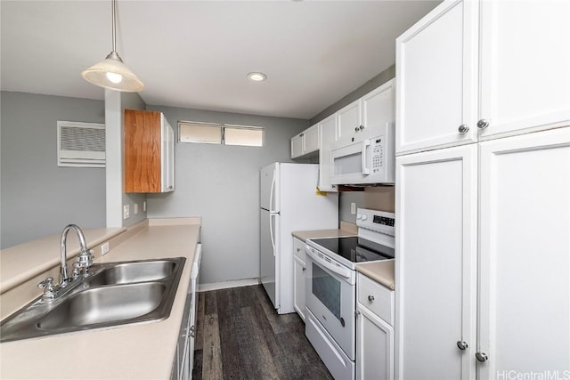 kitchen featuring a sink, light countertops, white cabinets, white appliances, and dark wood-style flooring