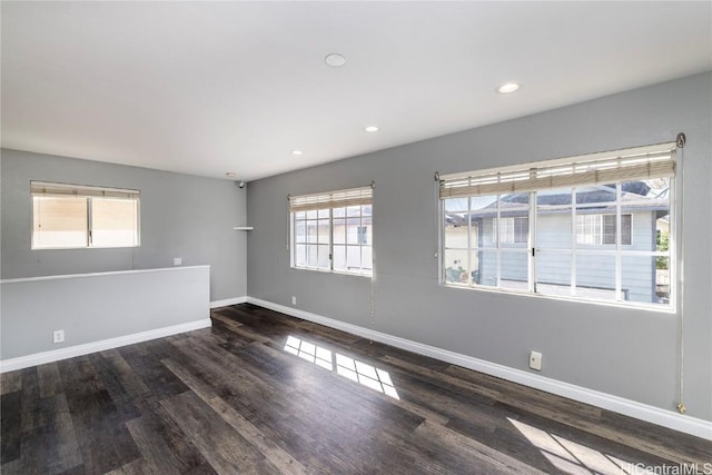 unfurnished room featuring recessed lighting, baseboards, and wood finished floors