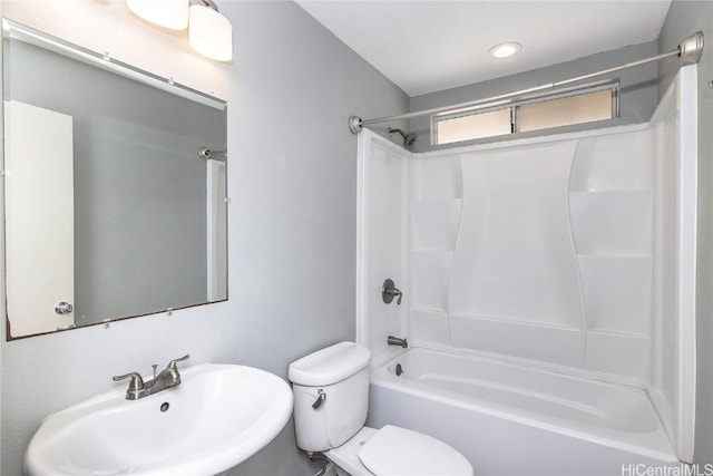 full bathroom featuring toilet, bathtub / shower combination, and a sink