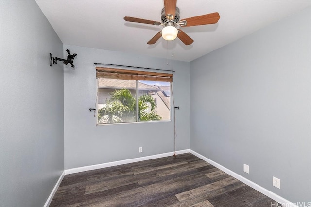 empty room featuring baseboards, ceiling fan, and dark wood-style flooring