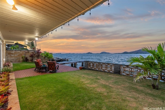 view of yard featuring a patio area and a water and mountain view