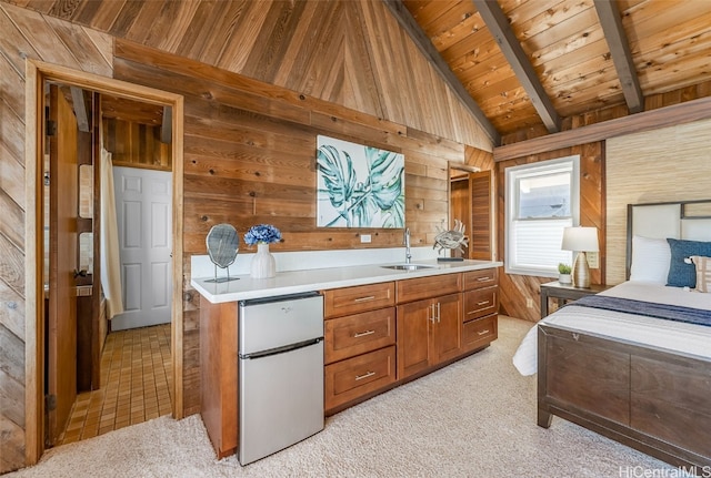 kitchen with wood walls, wood ceiling, light countertops, and a sink