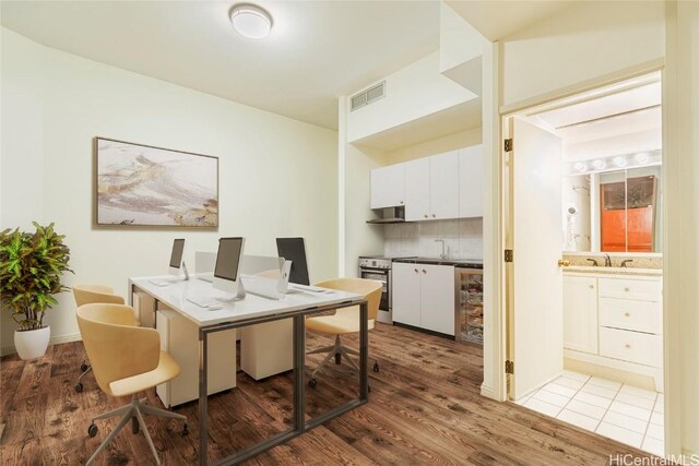 1088 Bishop St Unit 204, Honolulu, HI 96813 - office area with a sink, visible vents, and wood finished floors