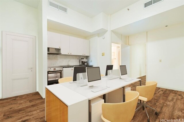 1088 Bishop St Unit 204, Honolulu, HI 96813 - kitchen with tasteful backsplash, visible vents, wall oven, and dark wood finished floors