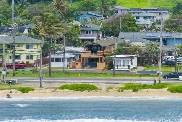 aerial view featuring a residential view, a water view, and a view of the beach