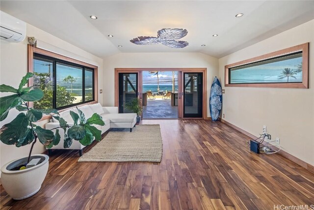 living room featuring recessed lighting, lofted ceiling, wood finished floors, and a wall mounted AC