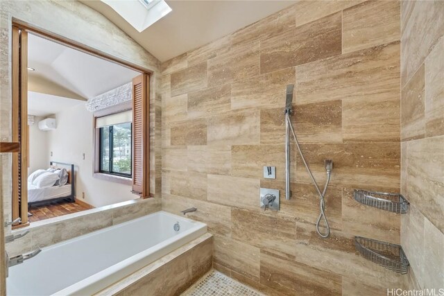 ensuite bathroom featuring vaulted ceiling with skylight, a garden tub, ensuite bathroom, and a tile shower