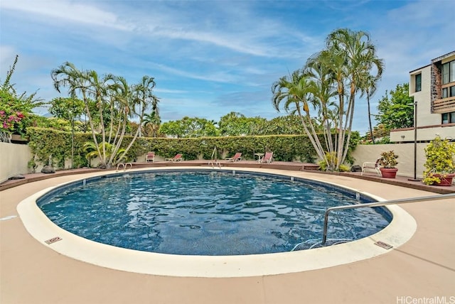 pool featuring a patio and a fenced backyard