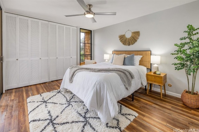 bedroom with a closet, a ceiling fan, baseboards, and wood finished floors