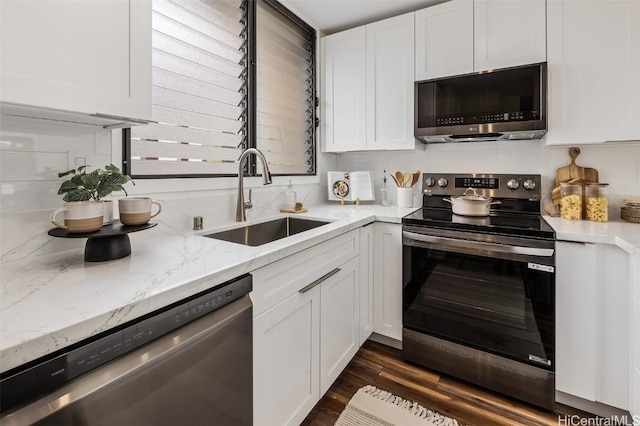 kitchen with white cabinetry, dark wood finished floors, appliances with stainless steel finishes, and a sink