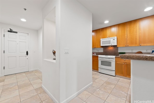 kitchen with white appliances, light tile patterned flooring, recessed lighting, and baseboards