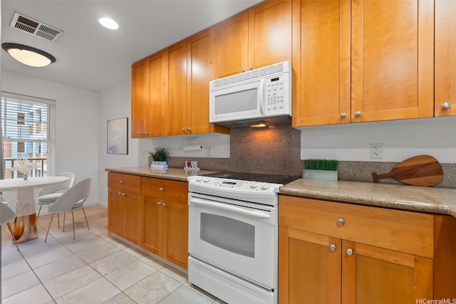 520 Lunalilo Home Rd Unit 8203, Honolulu, HI 96825 - kitchen featuring white appliances, light tile patterned flooring, light countertops, brown cabinets, and baseboards
