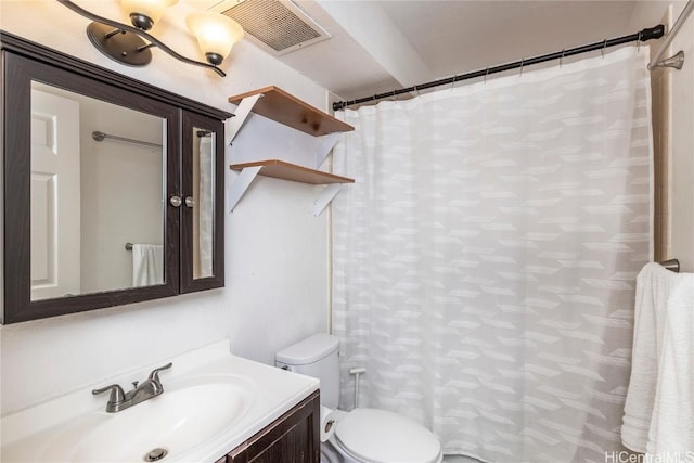 bathroom with visible vents, toilet, vanity, and a shower with curtain