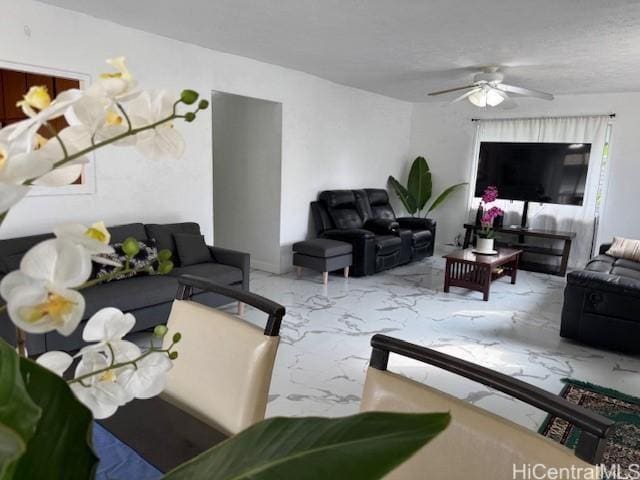 living room featuring marble finish floor and ceiling fan