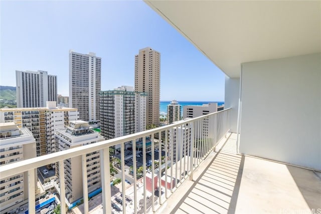 balcony featuring a view of city and a water view