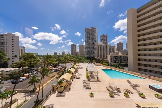 view of swimming pool featuring a city view