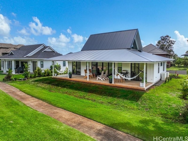 back of house with cooling unit, a lawn, and metal roof