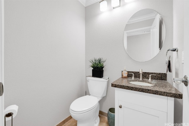 half bath featuring vanity, toilet, baseboards, and ornamental molding