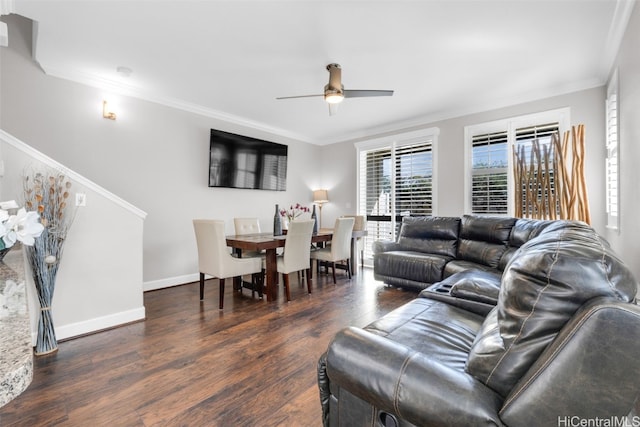 living room with baseboards, crown molding, a ceiling fan, and wood finished floors