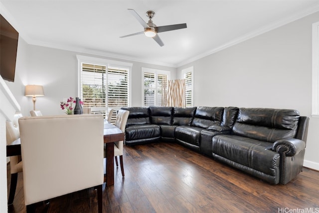 living area with crown molding, wood-type flooring, and ceiling fan