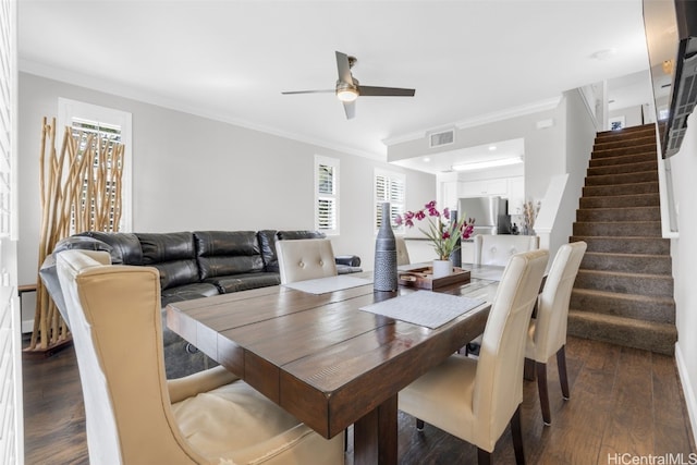 dining room with stairway, visible vents, dark wood finished floors, and crown molding