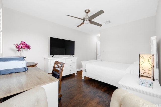 bedroom with ceiling fan, visible vents, and wood finished floors