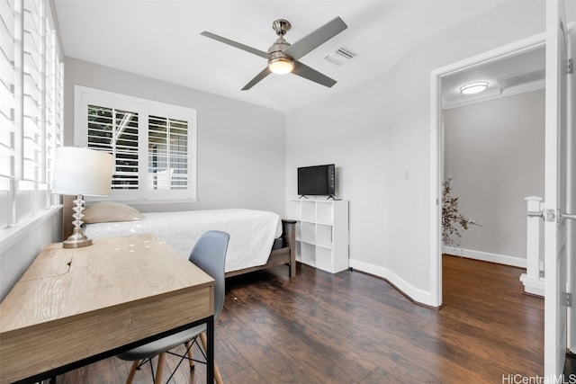 bedroom featuring a ceiling fan, wood finished floors, visible vents, and baseboards