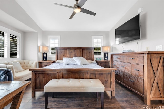 bedroom featuring multiple windows, lofted ceiling, a ceiling fan, and dark wood-style flooring