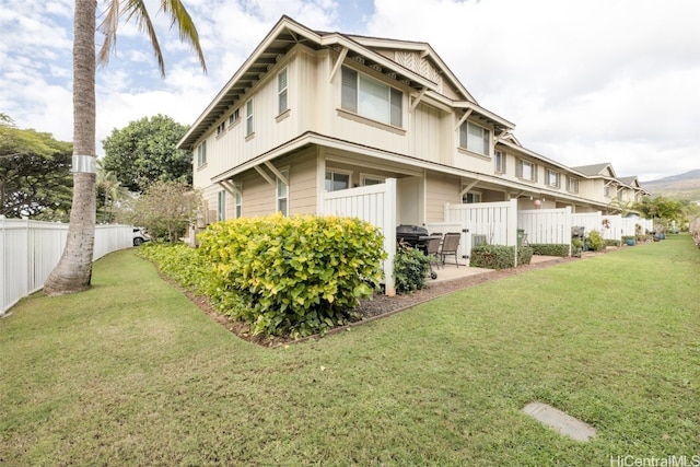 exterior space with a patio, a lawn, and fence