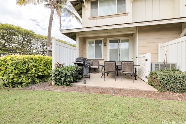 view of patio with area for grilling and fence