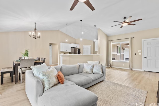 living area with baseboards, ceiling fan with notable chandelier, lofted ceiling, and light wood finished floors