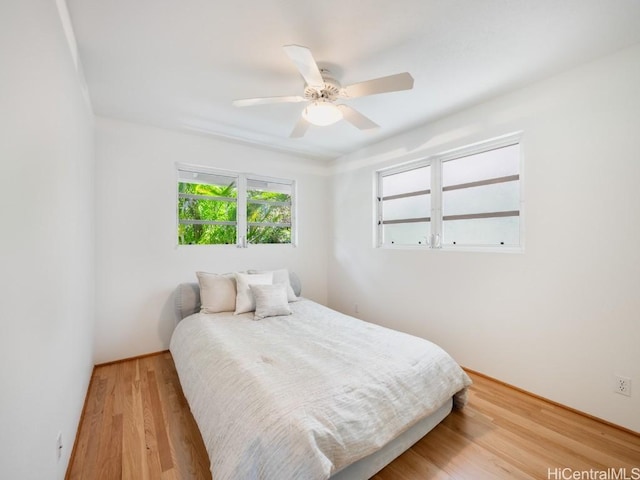 bedroom with wood finished floors and a ceiling fan