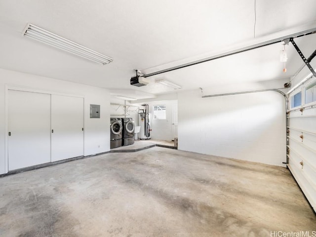 garage with concrete block wall, electric panel, water heater, a garage door opener, and independent washer and dryer