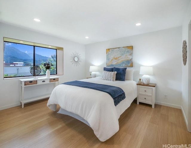 bedroom with recessed lighting, light wood-type flooring, and baseboards