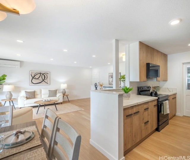 kitchen with backsplash, black range with electric stovetop, open floor plan, light wood-type flooring, and modern cabinets