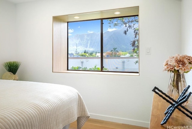 bedroom featuring wood finished floors and baseboards