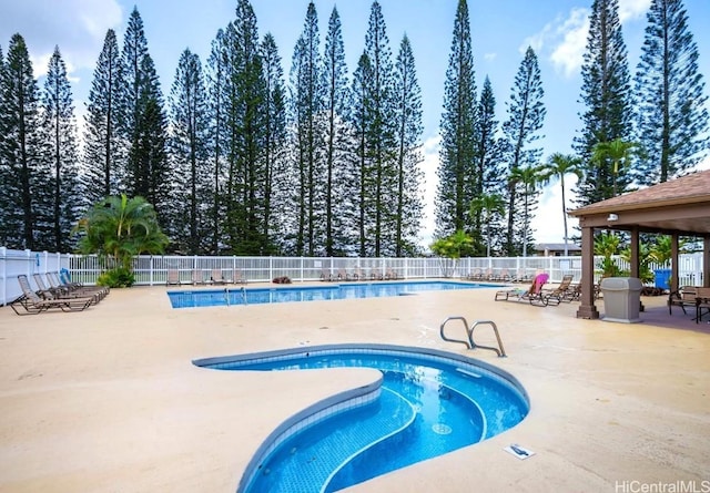 community pool featuring a patio and fence