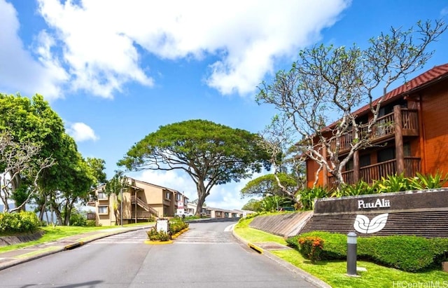 view of street with sidewalks, curbs, and a residential view